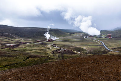 Geothermal power station at krafla volcano against sky