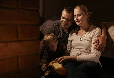 Smiling family in dark at home