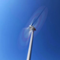 Low angle view of electric lamp against blue sky