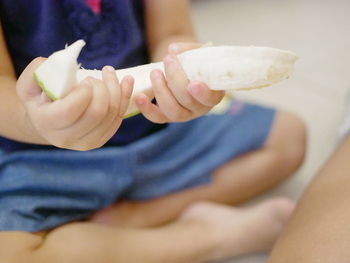 Baby hands learning to peel fruit, pomelo - involving babies in fruit preparation 
