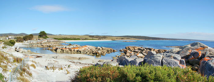 Panoramic view of sea against clear blue sky