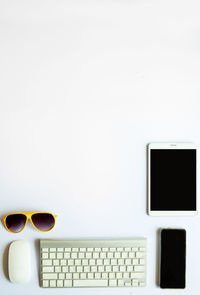 Directly above shot of sunglasses and laptop on table