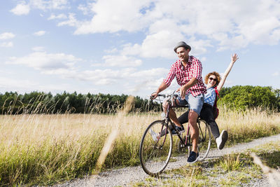 Happy young couple on a bicycle tour