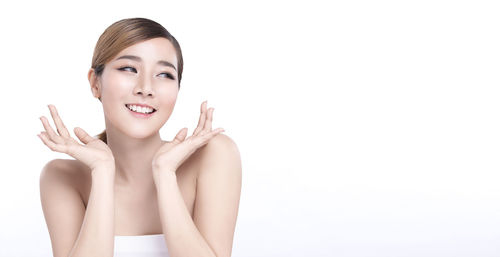 Portrait of a smiling young woman over white background