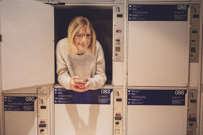 Young woman relaxing in locker