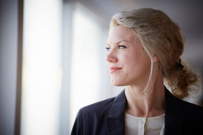 Confident businesswoman looking away at workplace