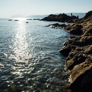 Scenic view of sea against sky during sunny day