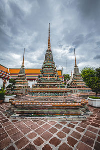 Low angle view of temple against cloudy sky