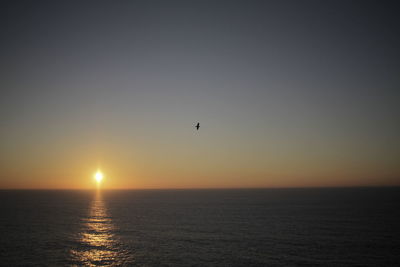 Scenic view of sea against clear sky during sunset