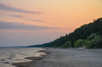 Scenic view of beach against sky during sunset