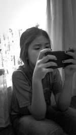 Man photographing while using smart phone