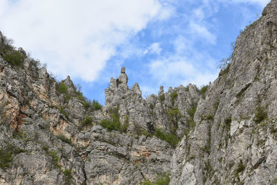 Low angle view of rocks against sky