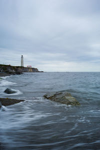 Scenic view of sea against cloudy sky