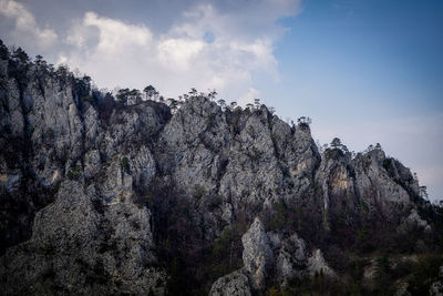 Low angle view of rock formation against sky