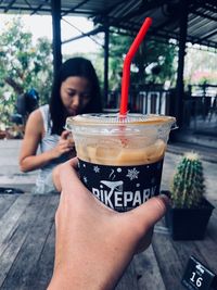 Midsection of woman drinking coffee