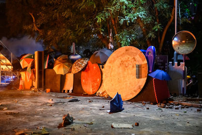 People working on street against trees at night