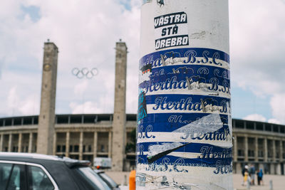 Information sign against sky in city