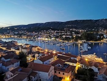 High angle view of townscape by sea against sky