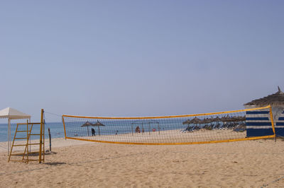 Scenic view of beach against clear blue sky