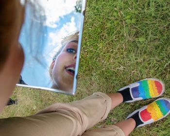 High angle portrait of woman lying on grass