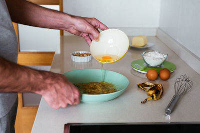 Young man making cookies at the kitchen