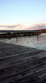 Pier on sea at sunset