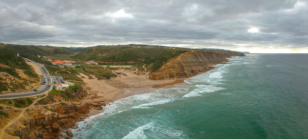 Aerial view of waves on a beautiful sandy ocean beach and cliff. panorama atlantic coastline.