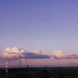 Houses and buildings against sky at sunset