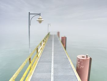 Pier over sea against sky