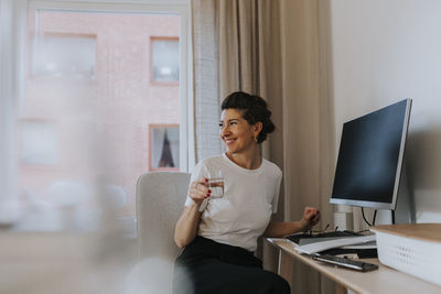 View of woman sitting at desk