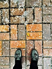 Low section of man standing on footpath