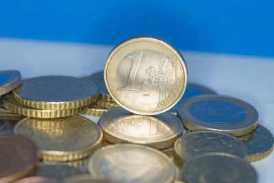 Close-up of coins against blue background