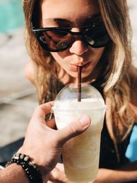 Close-up of woman drinking juice