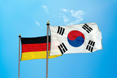 Flags against blue sky