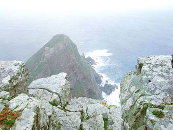 Scenic view of sea and mountains against sky