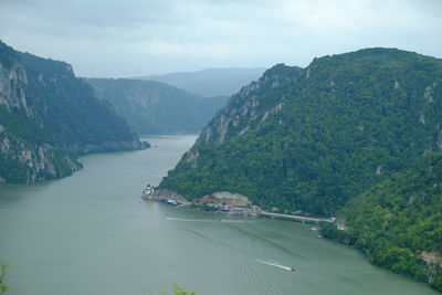 Scenic view of sea and mountains against sky