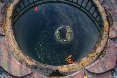 High angle view of coins in religious well