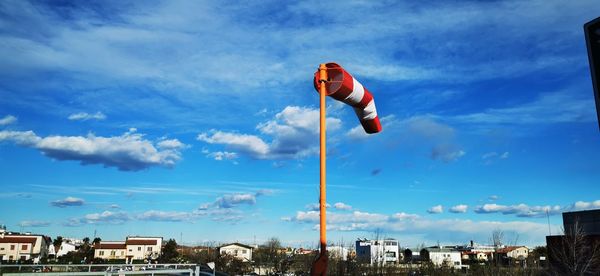 Low angle view of flag against buildings in city