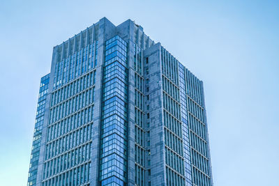 Low angle view of modern building against clear blue sky