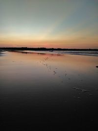 Scenic view of beach against sky during sunset