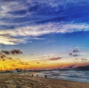 Scenic view of beach against sky during sunset