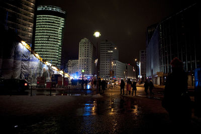 People walking in city at night