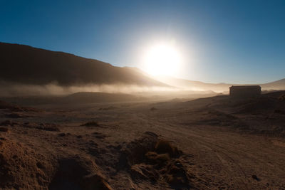 Scenic view of desert against sky during sunset