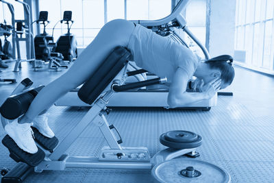 Low section of man exercising at gym