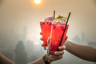 Close-up of hand holding red wine