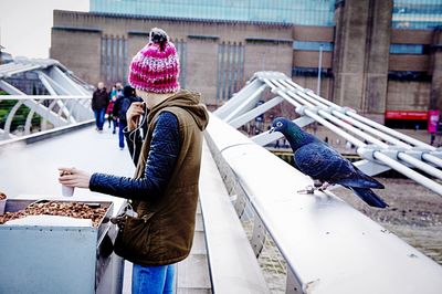 Woman standing by railing