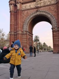 Full length of people in front of historical building