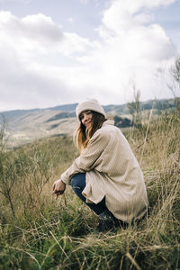 Woman wearing hat on field against sky