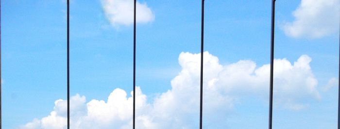 Low angle view of cables against blue sky