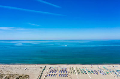 Bathouses and neatly ordered beach chairs and umbrellas